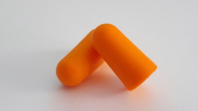 A pair of orange earplugs 