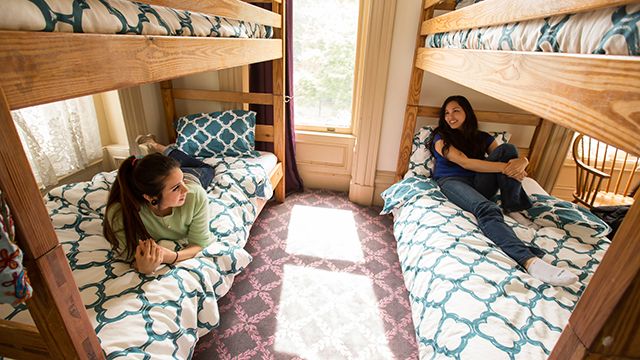 Two women in a dorm bed in a hostel